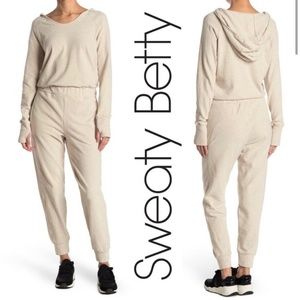 SWEATY BETTY | Jumpsuit Hibernate Luxe Hooded Jogger Oatmeal Marl